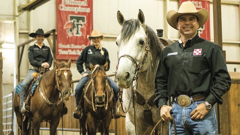 Texas Tech ranch horse trainer Chance O'Neal standing with horse and team members