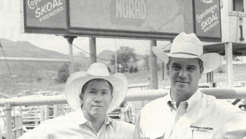 Randy Barnes and Steve Scribner standing in front of rodeo scoreboard