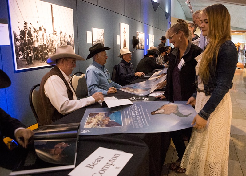 Attendees line up to have Cowboy Crossings posters signed by members of the Cowboy Artists of America and Traditional Cowboy Arts Association