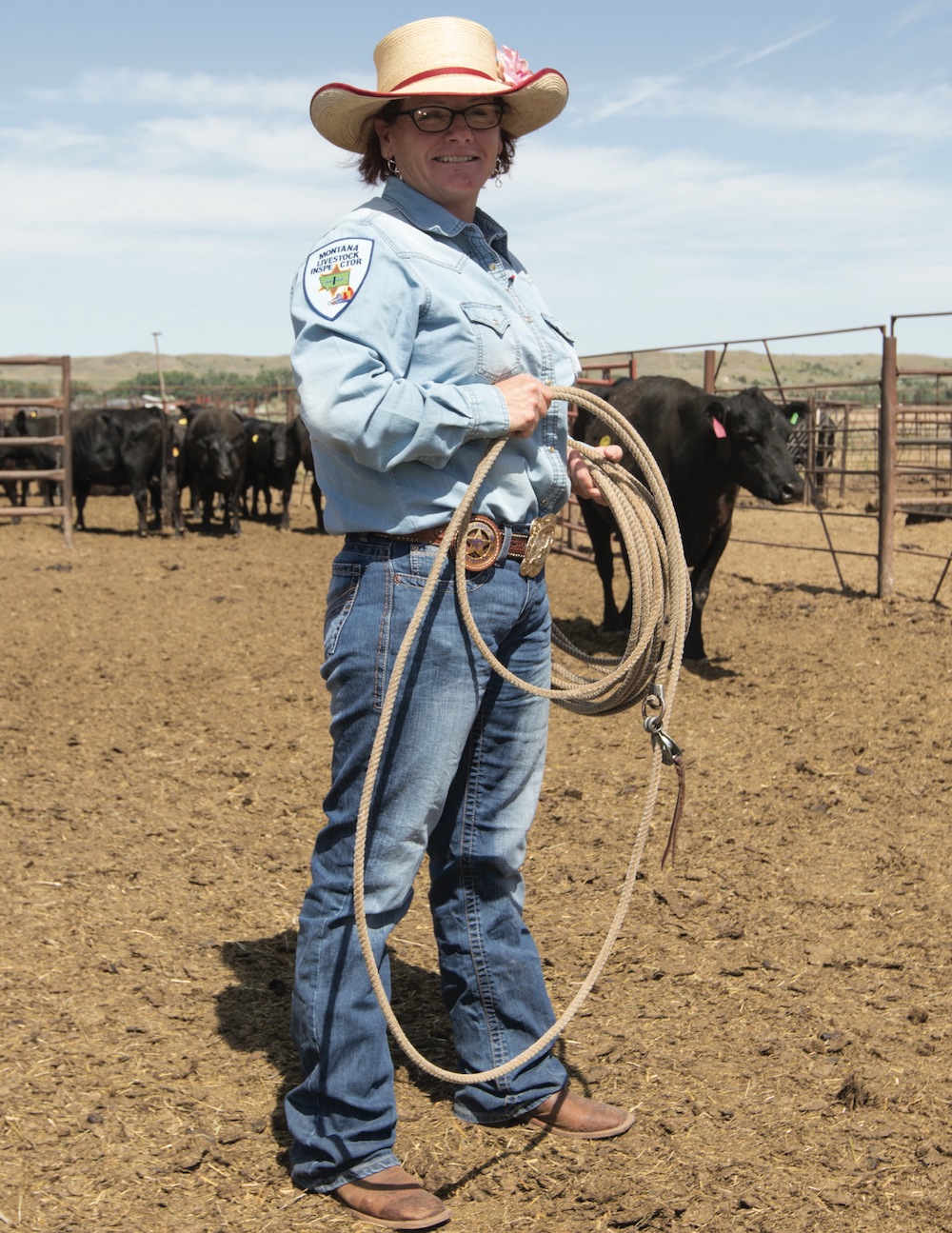 Robin Blankenship standing in pen with cattle