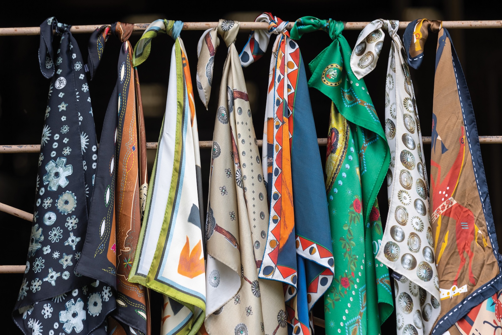 row of fringe scarves tied to a gate