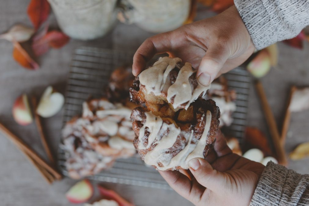 apple fritter with hands